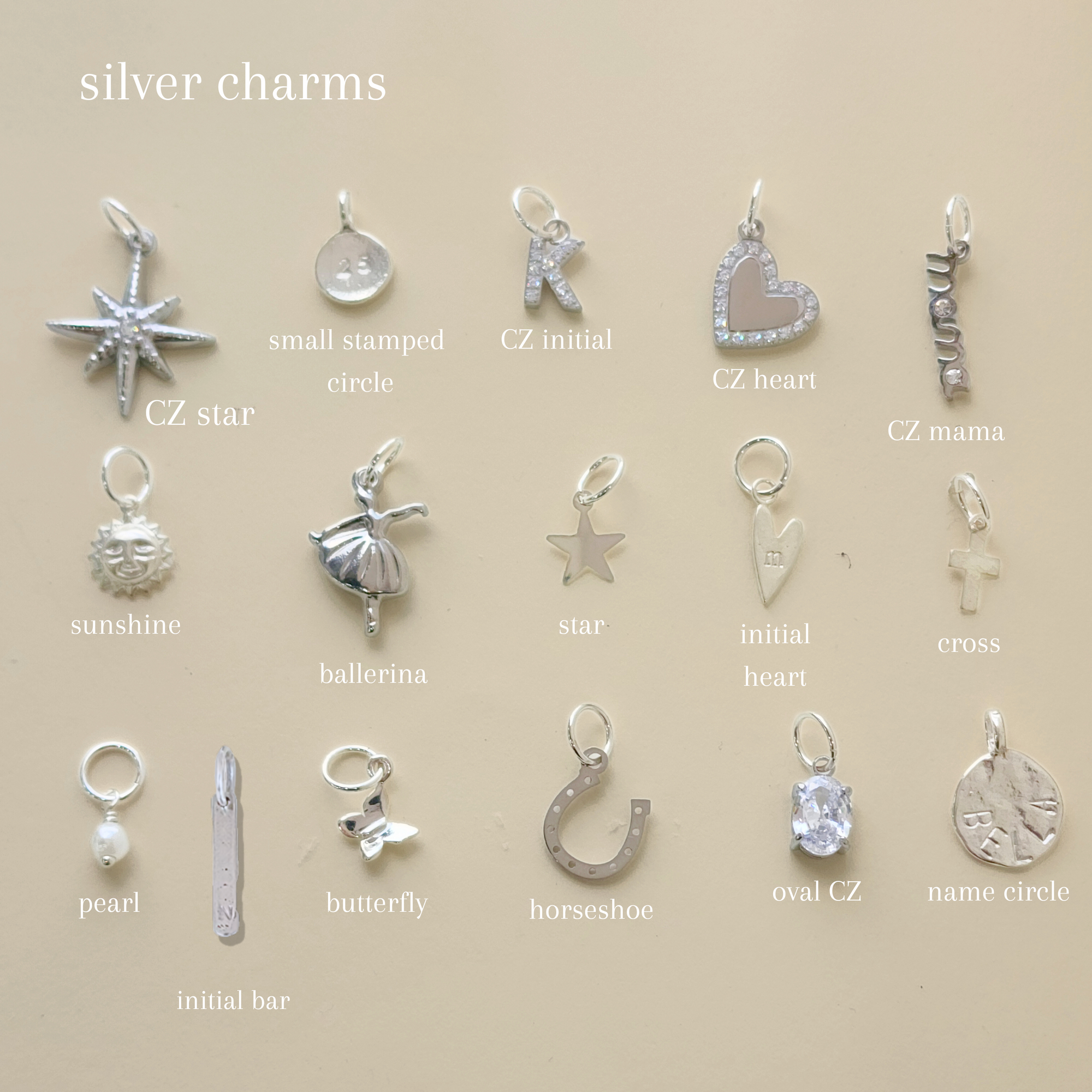 Collection of silver charms on a beige background with labels.