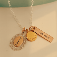 Necklace with gold and bronze pendants on a light background