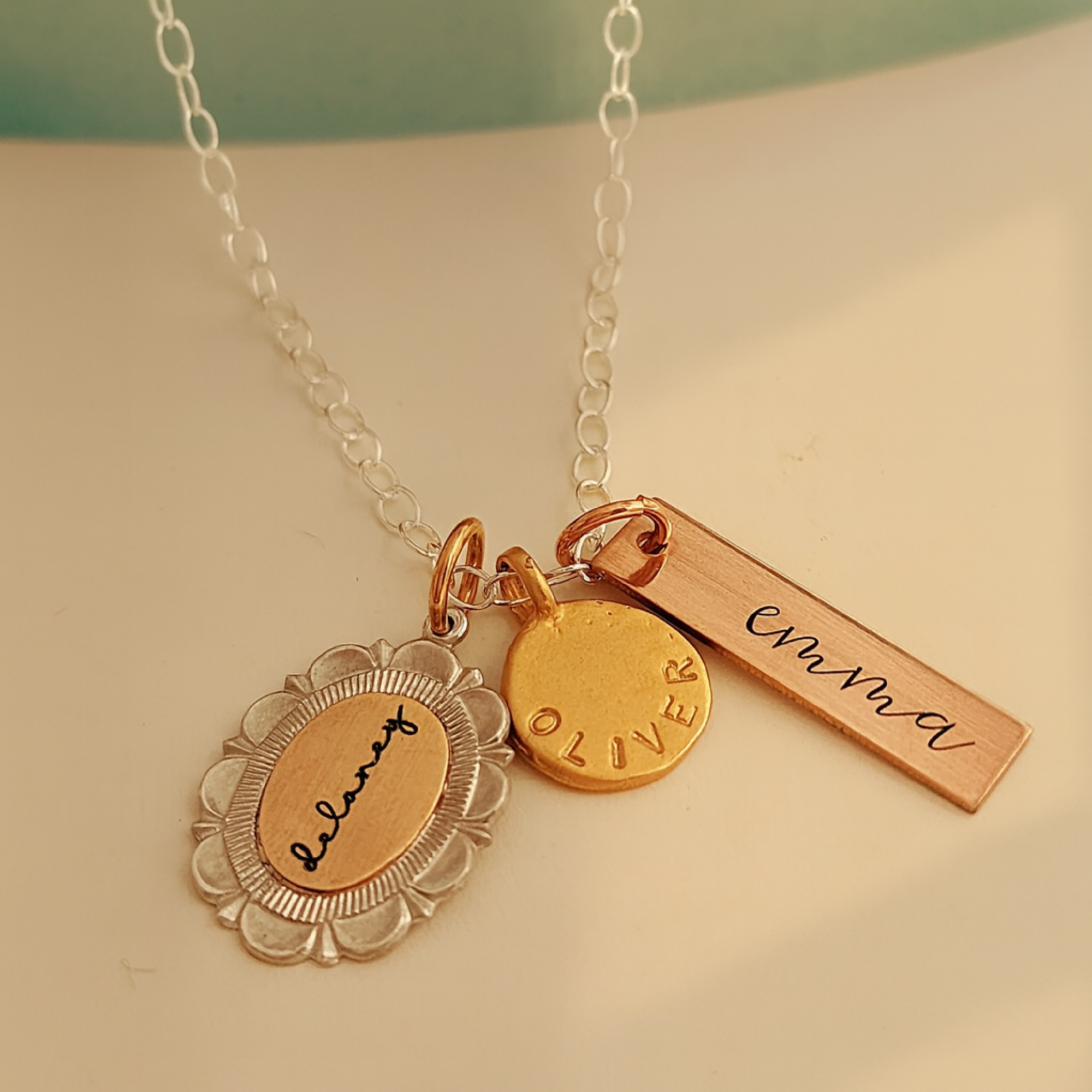 Necklace with gold and bronze pendants on a light background