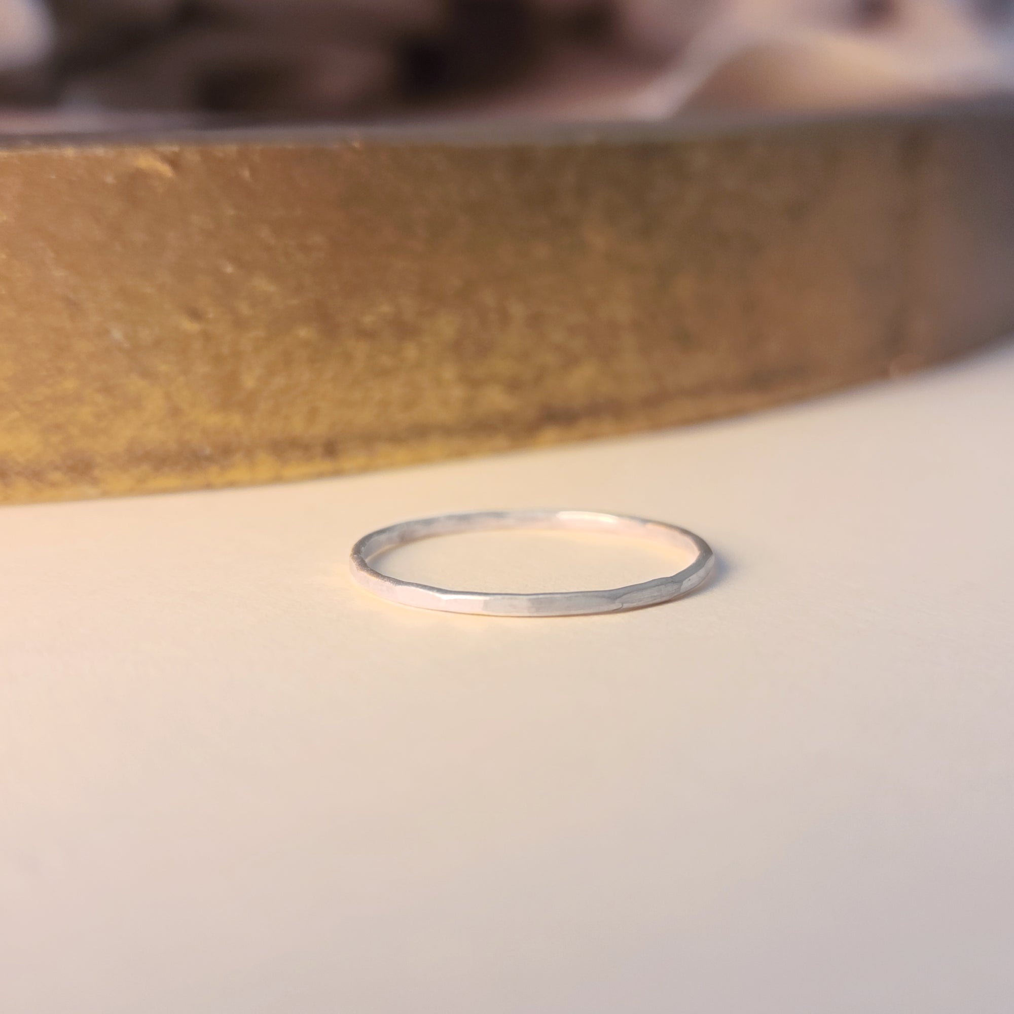 Thin silver ring on a light background
