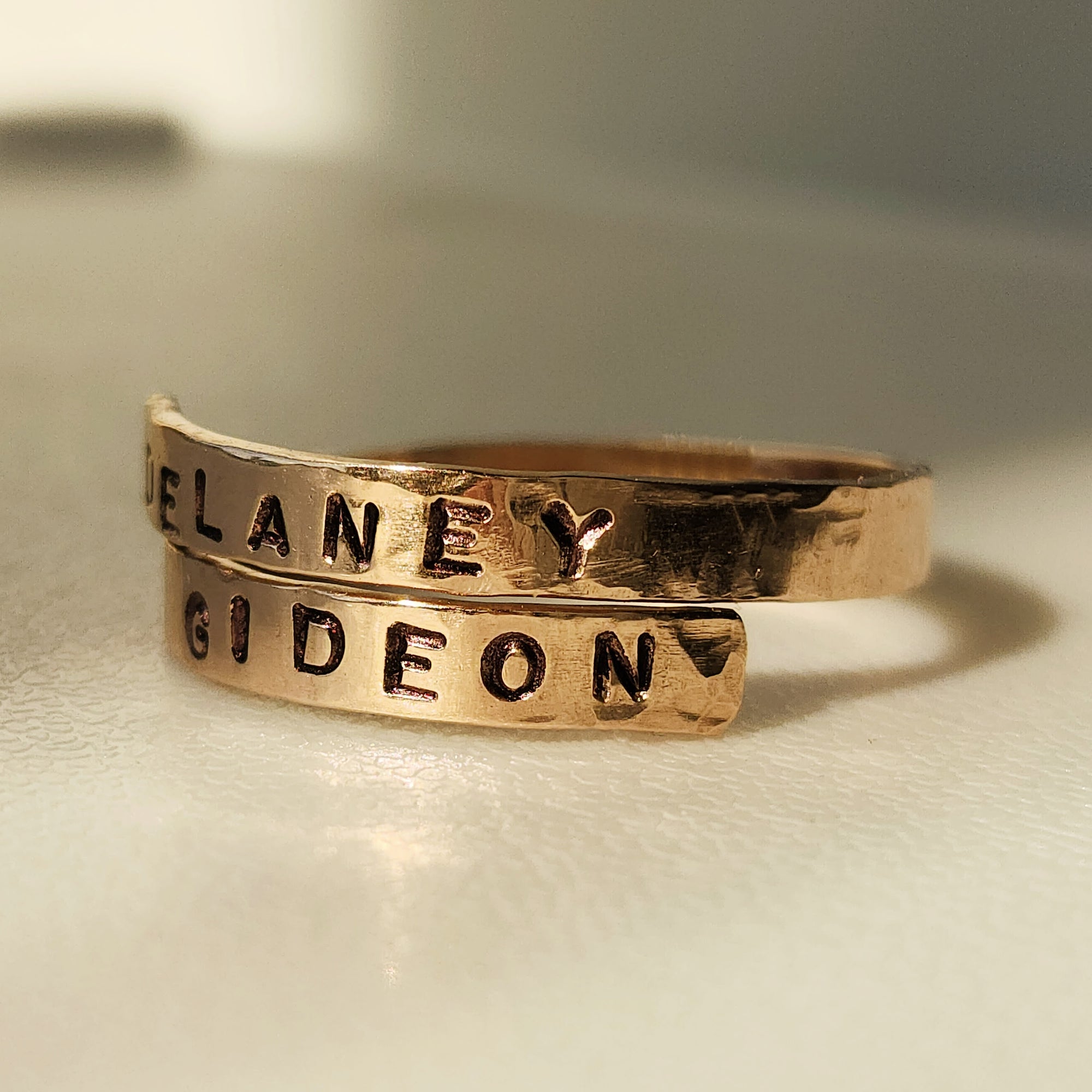 Adjustable gold filled wrap ring with stamped names Delaney and Gideon