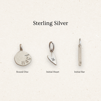 Three sterling silver charms on a light background with 'Sterling Silver' text.