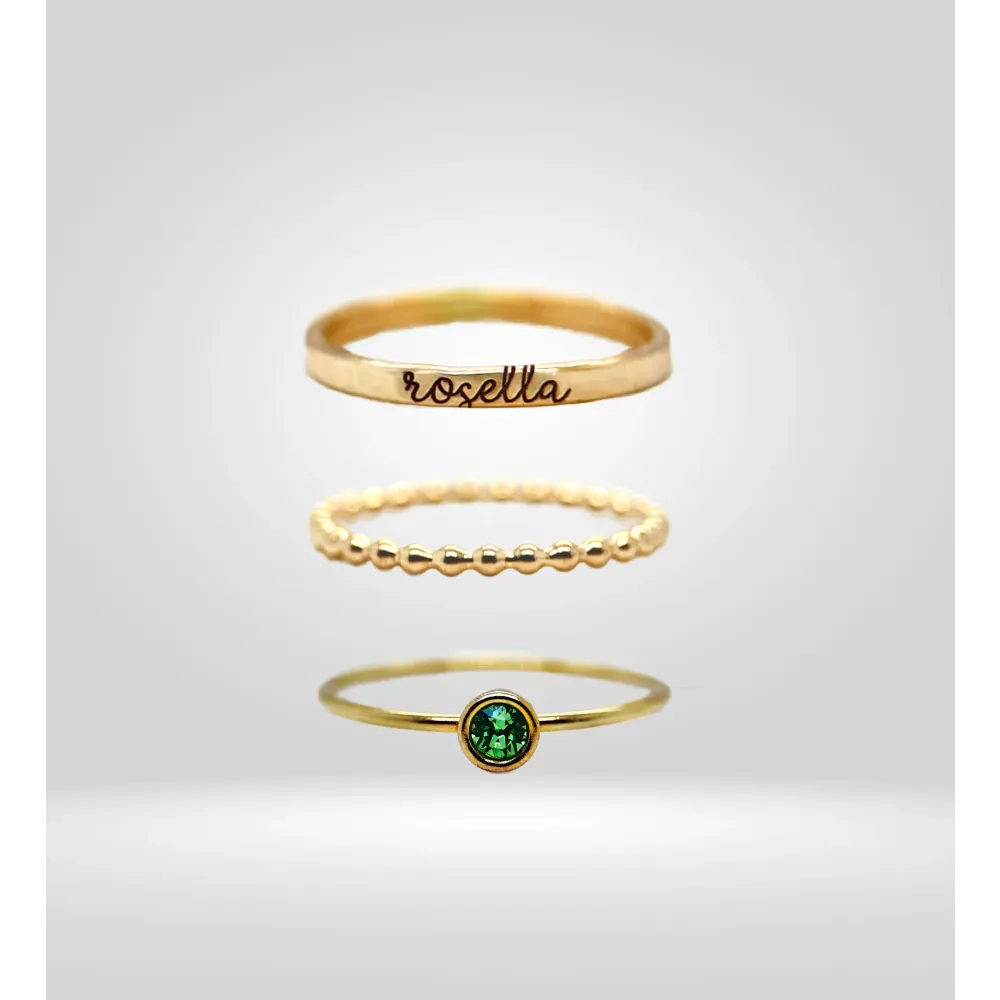 Stackable gold rings with emerald and engraved design