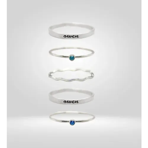 Tyi Jewelry rings, including Owen name ring and blue gemstone rings