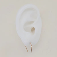 U-shaped earrings shown on white silicone ear display
