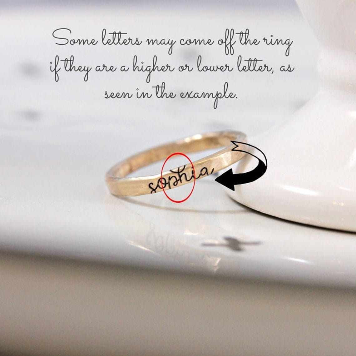 Close-up of a custom engraved gold ring showing letter alignment detail for personalized design your own ring set